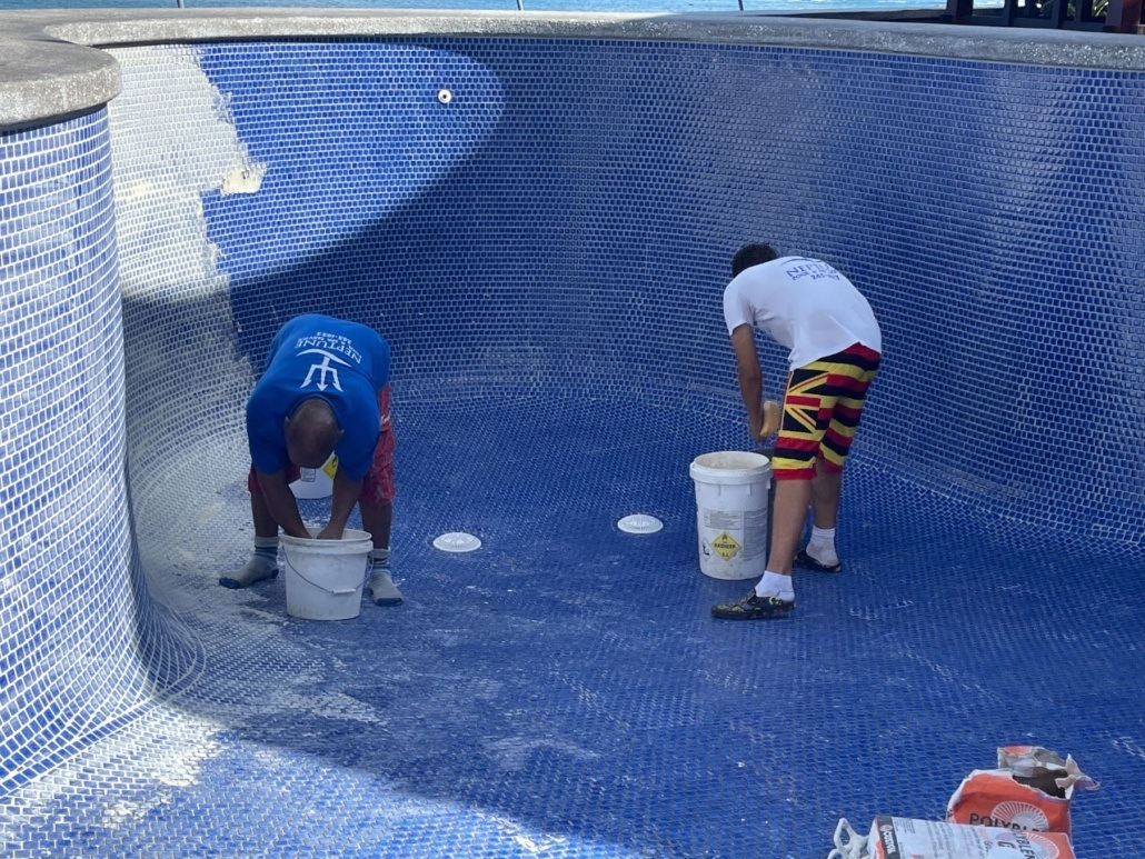 Honolulu pool cleaning services near me being performed by Neptune employees. Pool cleaning Oahu.