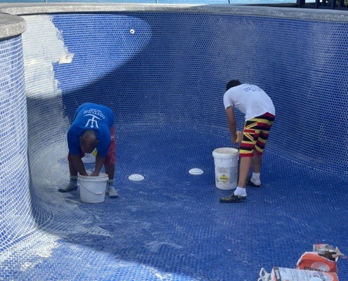 Honolulu pool cleaning services near me being performed by Neptune employees. Pool cleaning Oahu.