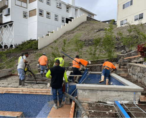 Oahu pool builders pouring concrete during pool & spa installation, Honolulu.