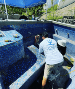 Neptune employee during Hawaii pool tile installation, Oahu.