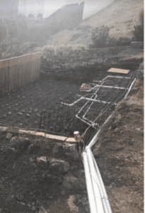 Taken during the pool excavation phase this image shows temporary ground supports and concrete forms.