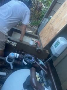 Oahu pool repair technician checking for pool equipment leaks.